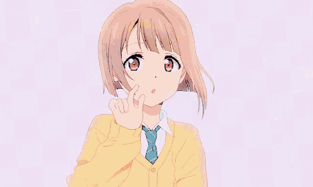 a girl in a school uniform is smiling and making a heart shape with her hands