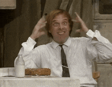 a man in a white shirt and tie is sitting at a table with a bottle of milk and a piece of cake