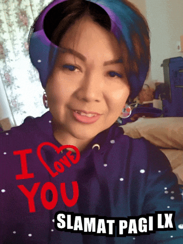 a woman is wearing a purple hoodie with the words i love you written on it