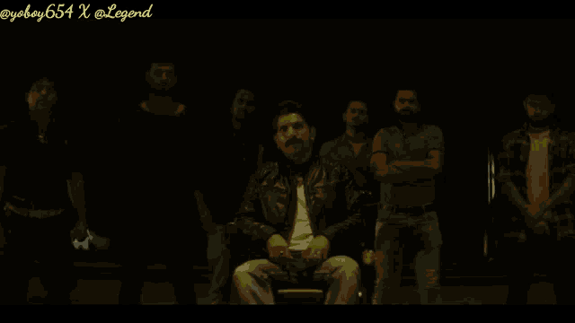 a man with a mustache is sitting in front of a group of men with the caption " bunty to chocolate hai "