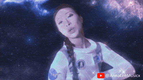 a woman in a nasa uniform stands in front of a galaxy and a youtube logo