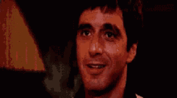 a close up of a man 's face with his eyes closed and smiling .