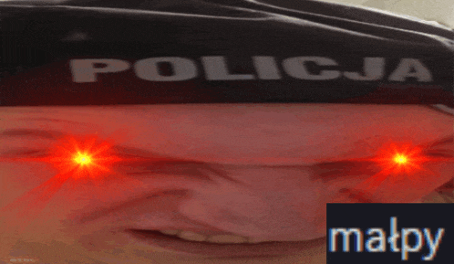 a close up of a person 's face with the word policja on it