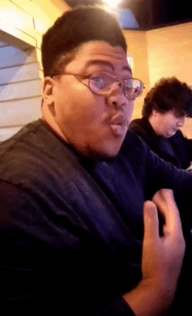a man with glasses making a funny face