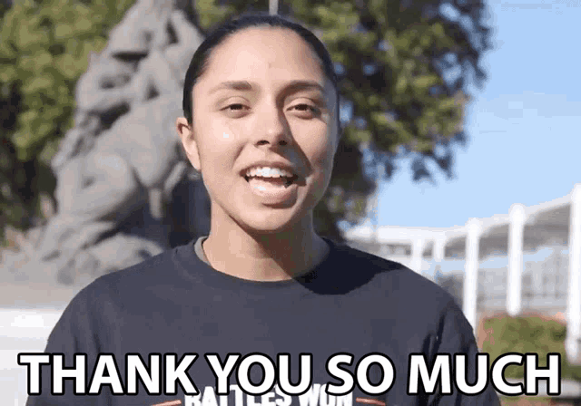 a woman says " thank you so much " in front of a statue