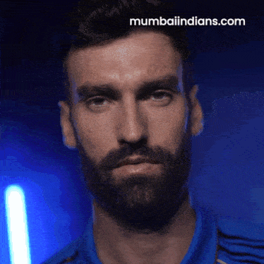 a close up of a man 's face with the website mumbaiindians.com visible in the corner
