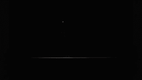 a person is standing in the dark with a light behind them