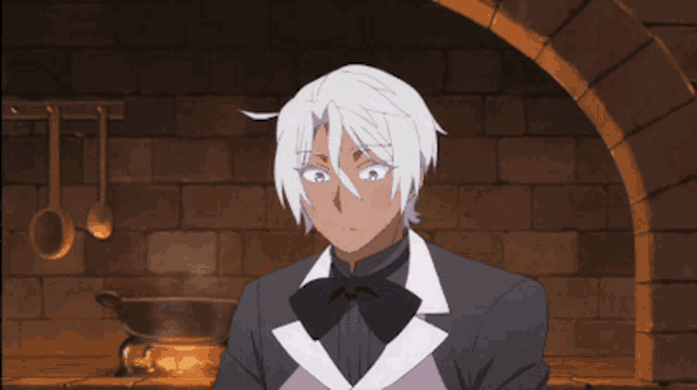 a man in a suit and bow tie is eating something with a spoon