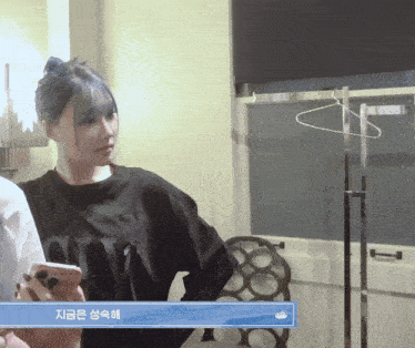 a woman wearing a black shirt with the word love on the front