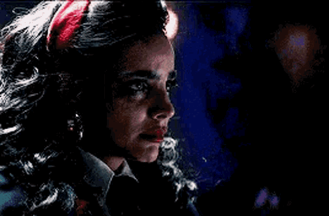 a close up of a woman 's face with a red headband .