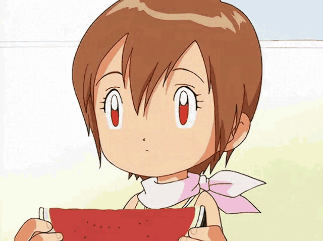 a little girl is holding a slice of watermelon in her hands