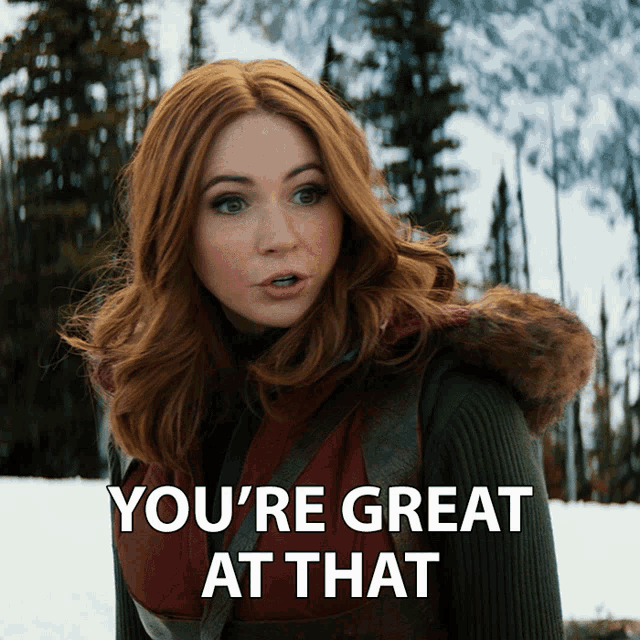 a woman with red hair says " you 're great at that " while standing in the snow