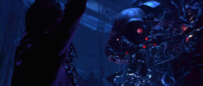 a man is standing in front of a robot that has red eyes