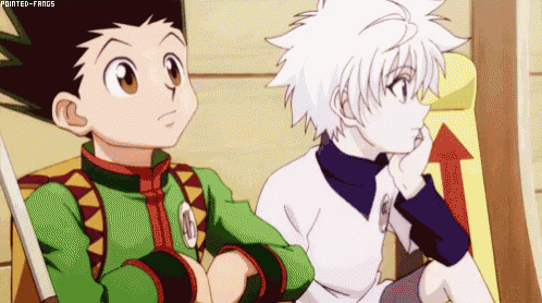 two anime characters , gon and killua , are sitting next to each other in a chair .