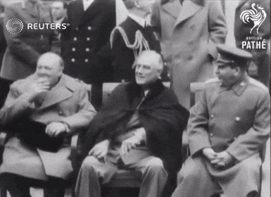 a group of men are sitting in front of a sign that says pathe