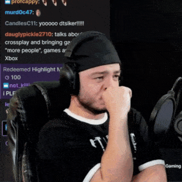 a man wearing headphones is sitting in front of a microphone and a screen that says redeemed highlight 100