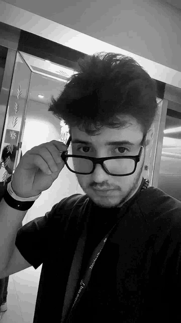 a man wearing glasses and a lanyard that says ' i love you '