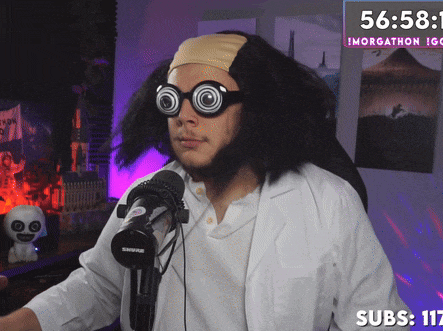 a man wearing glasses and a headband is sitting in front of a microphone with the time of 56:58