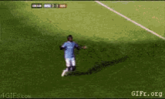 a man in a blue shirt is running on a soccer field with a score of 1-1