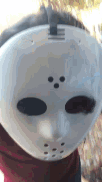 a person wearing a jason voorhees mask on their face