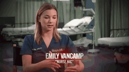 emily vancamp is a nurse who is sitting in a chair