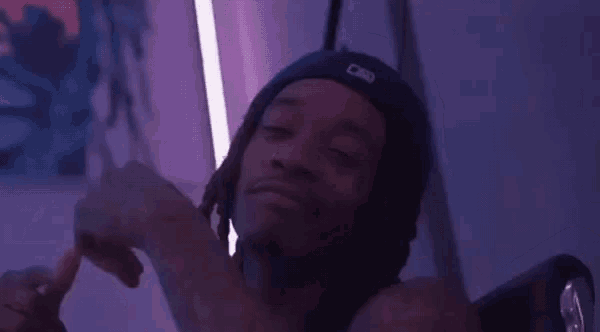 a man with dreadlocks wearing a hat that says ny