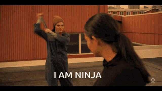 a woman is holding a sword and the words i am ninja are on the screen