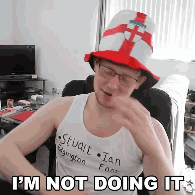 a man wearing a hat and a tank top that says stuart ian foot