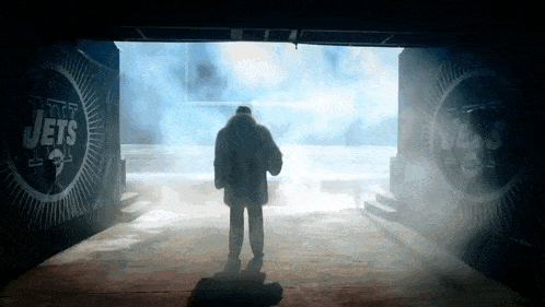 a man is walking through a tunnel that says jets