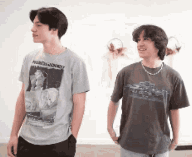 two young men standing next to each other one wearing a t-shirt that says phantom ghost