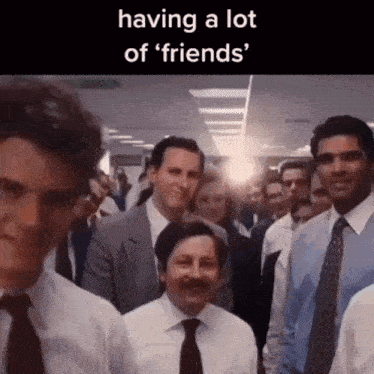 a group of men in suits and ties are standing in a room with the caption having a lot of friends .