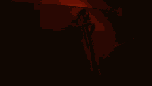 a blurry picture of a person smoking a cigarette in the dark
