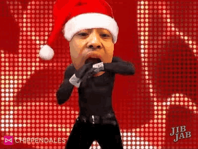 a man is wearing a santa hat and dancing .
