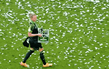 a soccer player is carrying a box of beck 's beer on the field