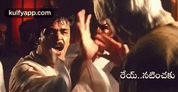 a man is yelling at another man in a crowd of people in a movie scene .