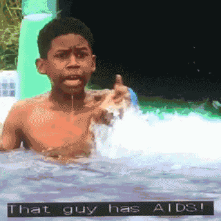 a boy is swimming in a pool with the words that guy has aids on the bottom