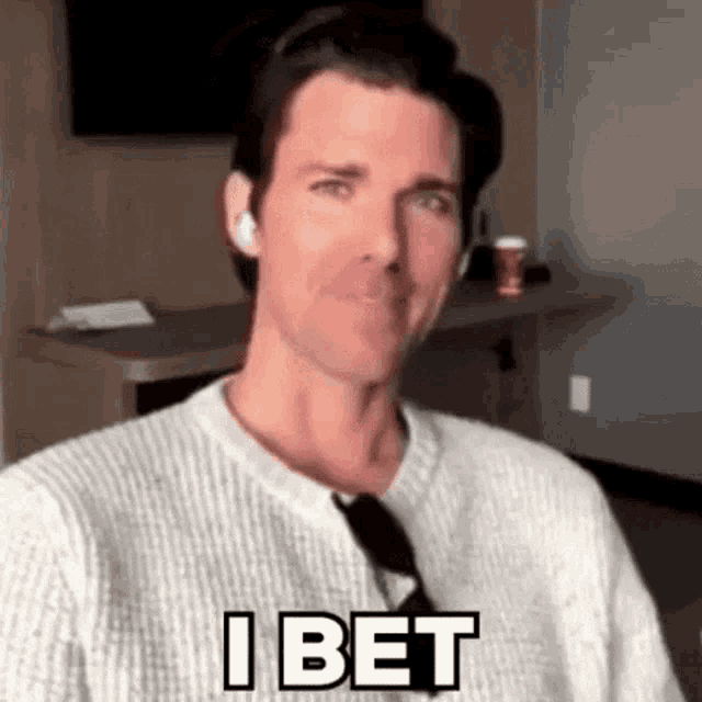 a man wearing a white sweater and sunglasses is making a funny face and says `` i bet '' .