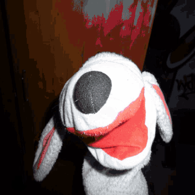 a sock puppet with a red nose and black eye