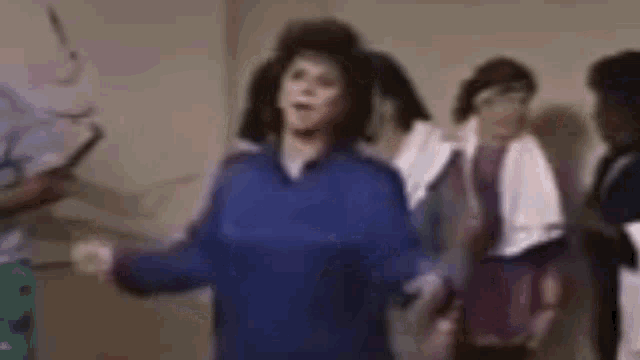 a woman is dancing in a room with other people .