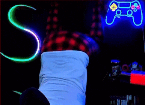 a person is doing a handstand in front of a neon sign that says ' s ' on it .