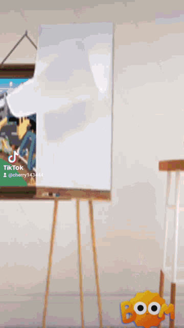 a cartoon character is standing in front of an easel with a painting on it