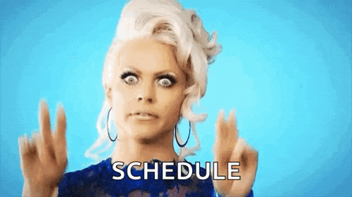 a woman in a blue dress is making a funny face and the word schedule is on the screen .