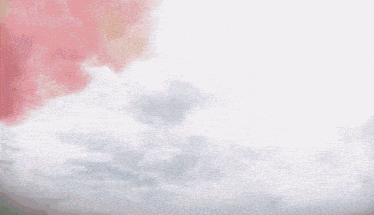 a rainbow of colors is coming out of a cloudy sky