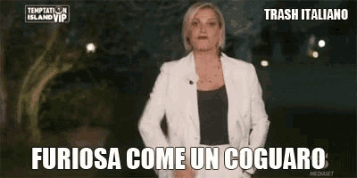 a woman in a white jacket is standing in front of a sign that says trash italiano
