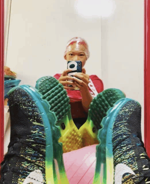 a person is taking a picture of themselves in a mirror with a phone that says ' supreme ' on it