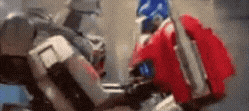 a blurry picture of two robots standing next to each other in a room .