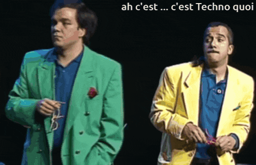 a man in a green jacket and a man in a yellow jacket are standing next to each other on a stage