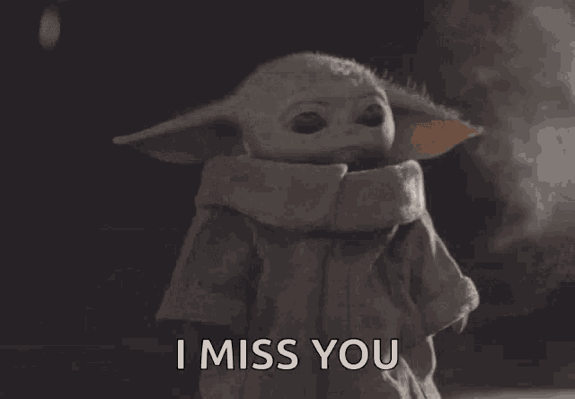 a baby yoda says " i miss you " in a dark background