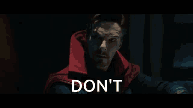 a person is holding a spider web in front of a box that says " do n't "