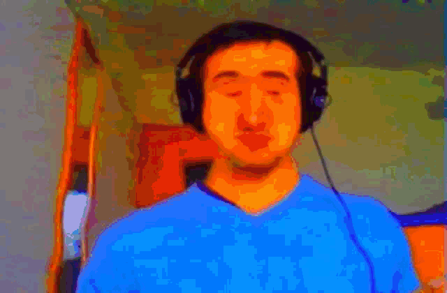a man wearing headphones and a blue shirt